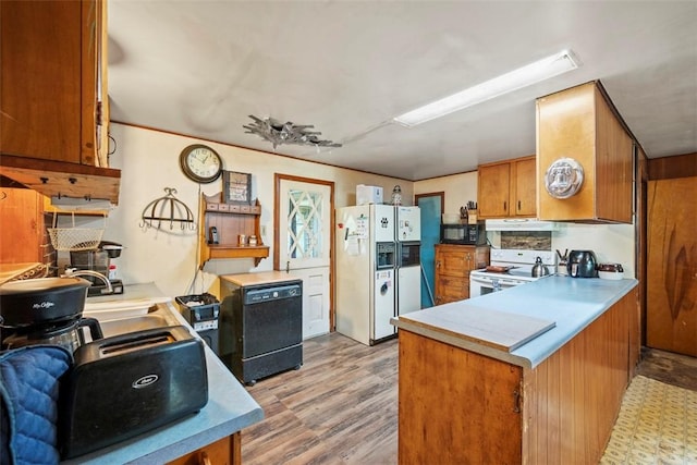 2158 Reis Run Rd, Franklin Park, PA 15237 - kitchen with black appliances, under cabinet range hood, brown cabinets, and a peninsula