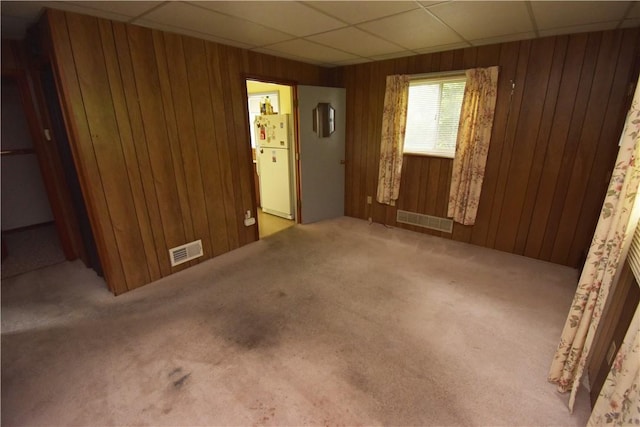 1323 Leaside Dr, Lincoln Place, PA 15207 - carpeted empty room featuring wood walls and a drop ceiling