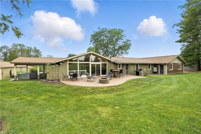 251 Myers Ln, Indiana Twp, PA 15101 - rear view of property with a hot tub, an outdoor fire pit, a patio, a lawn, and brick siding