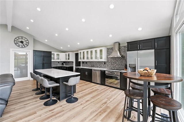 251 Myers Ln, Indiana Twp, PA 15101 - kitchen with appliances with stainless steel finishes, wall chimney exhaust hood, a kitchen island, tasteful backsplash, and beam ceiling