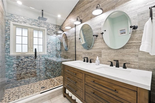 251 Myers Ln, Indiana Twp, PA 15101 - bathroom with double vanity, a shower stall, vaulted ceiling, tile walls, and tile patterned floors