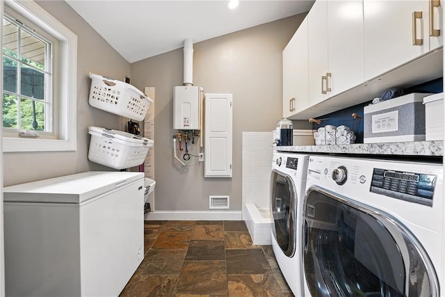 251 Myers Ln, Indiana Twp, PA 15101 - laundry room with washing machine and dryer, cabinet space, stone tile flooring, recessed lighting, and water heater