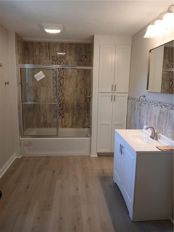 1211 Reed St, North Huntingdon, PA 15642 - full bathroom with vanity, shower / bath combination with glass door, and wood finished floors