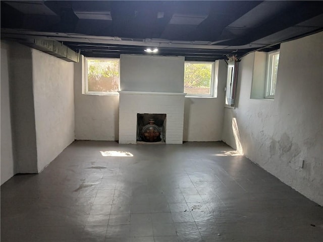 1211 Reed St, North Huntingdon, PA 15642 - basement with a brick fireplace and tile patterned floors