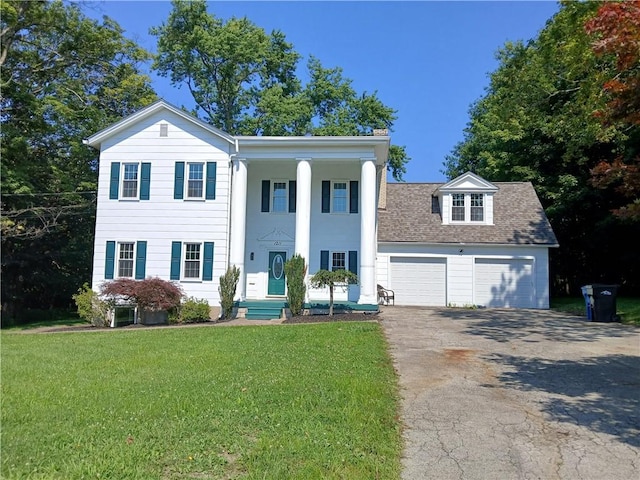 1211 Reed St, North Huntingdon, PA 15642 - neoclassical / greek revival house with driveway, a front lawn, a garage, and a shingled roof