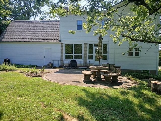 1211 Reed St, North Huntingdon, PA 15642 - back of property with a yard, a patio area, and roof with shingles