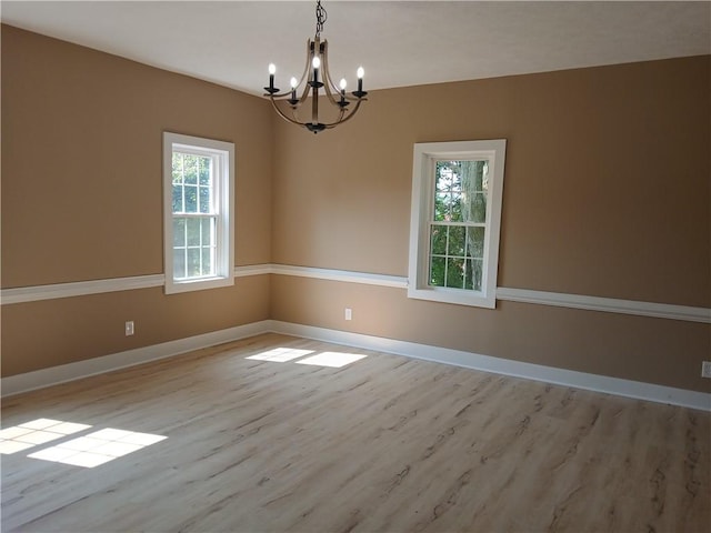 1211 Reed St, North Huntingdon, PA 15642 - empty room with a chandelier and wood finished floors
