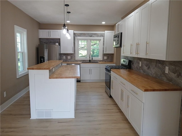 1211 Reed St, North Huntingdon, PA 15642 - kitchen with butcher block counters, appliances with stainless steel finishes, white cabinets, and recessed lighting