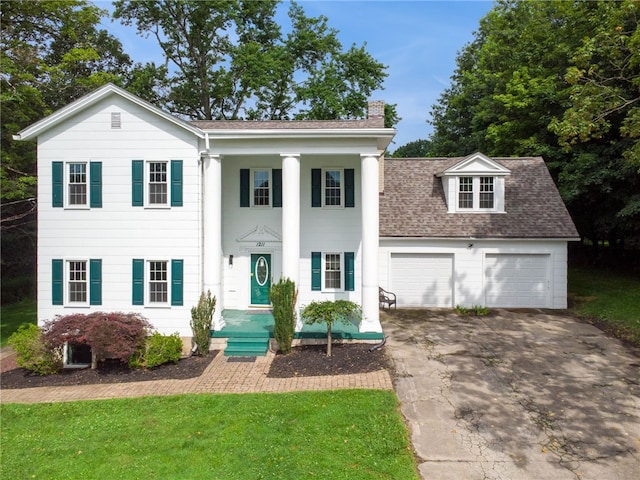 1211 Reed St, North Huntingdon, PA 15642 - greek revival inspired property with a chimney, driveway, an attached garage, a front yard, and roof with shingles