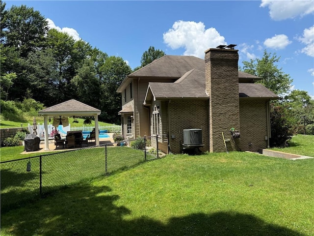 293 Sandy Hill Rd, Middlesex Twp, PA 16059 - back of property with a gazebo, a fenced backyard, brick siding, a chimney, and a patio