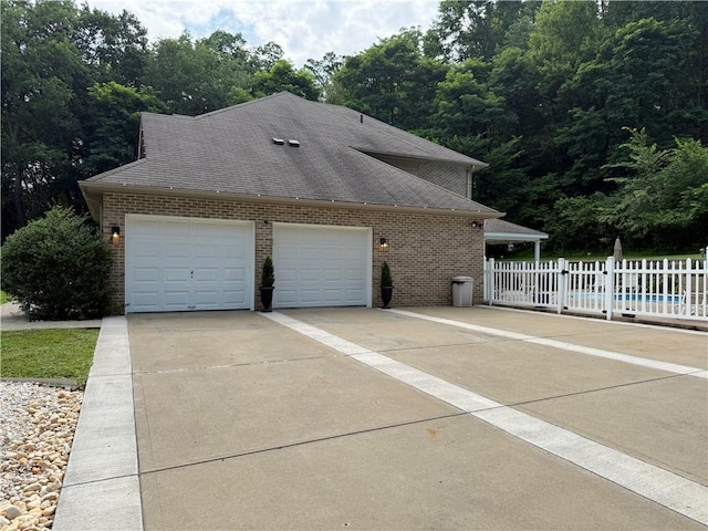 293 Sandy Hill Rd, Middlesex Twp, PA 16059 - view of side of property featuring concrete driveway, brick siding, a garage, and roof with shingles