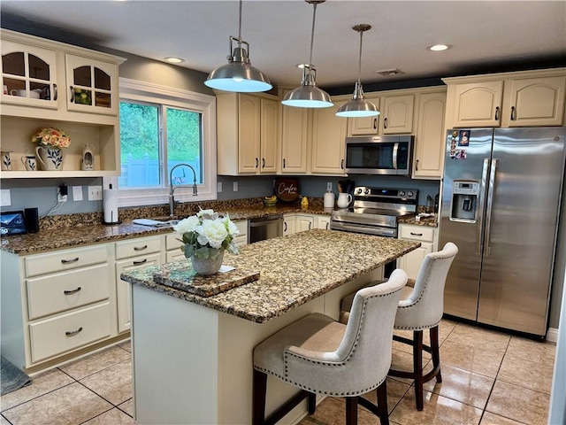 293 Sandy Hill Rd, Middlesex Twp, PA 16059 - kitchen with appliances with stainless steel finishes, a kitchen island, dark stone countertops, light tile patterned floors, and recessed lighting