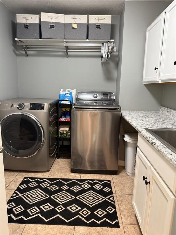 293 Sandy Hill Rd, Middlesex Twp, PA 16059 - laundry area featuring independent washer and dryer, cabinet space, and light tile patterned flooring