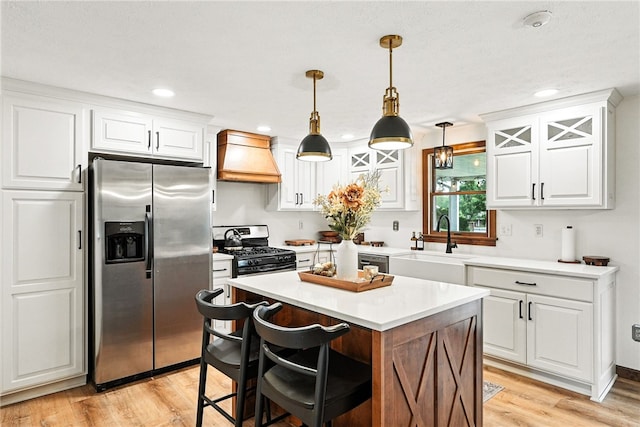 314 Shannon Cir, Daugherty Twp, PA 15066 - kitchen featuring stainless steel appliances, custom exhaust hood, light wood-type flooring, light countertops, and white cabinets