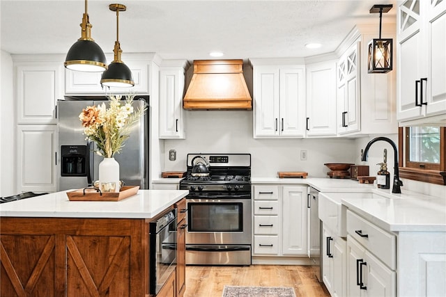 314 Shannon Cir, Daugherty Twp, PA 15066 - kitchen featuring premium range hood, stainless steel appliances, light countertops, white cabinets, and recessed lighting