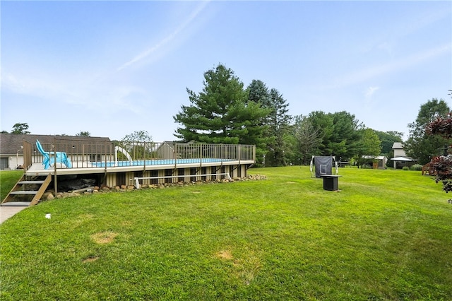 314 Shannon Cir, Daugherty Twp, PA 15066 - view of grassy yard featuring a wooden deck and an outdoor pool