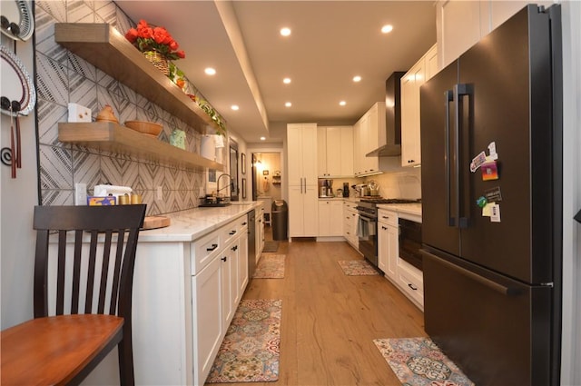 710 Cedar Ave, Central North Side, PA 15212 - kitchen featuring premium appliances, open shelves, wall chimney range hood, light wood-style floors, and white cabinets