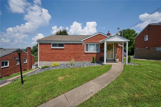 1023 Bellair Rd, Port Vue, PA 15133 - view of front of house with brick siding and a front yard