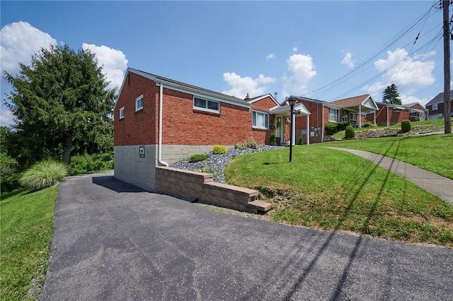 1023 Bellair Rd, Port Vue, PA 15133 - view of home's exterior featuring brick siding and a yard