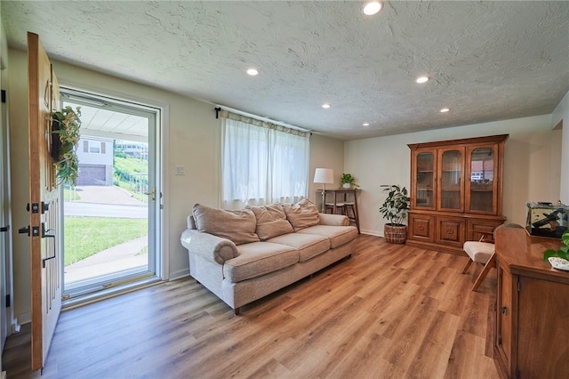 1023 Bellair Rd, Port Vue, PA 15133 - living room with light wood-style flooring, recessed lighting, and a textured ceiling
