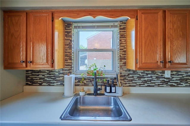 1023 Bellair Rd, Port Vue, PA 15133 - kitchen with light countertops, backsplash, and brown cabinets