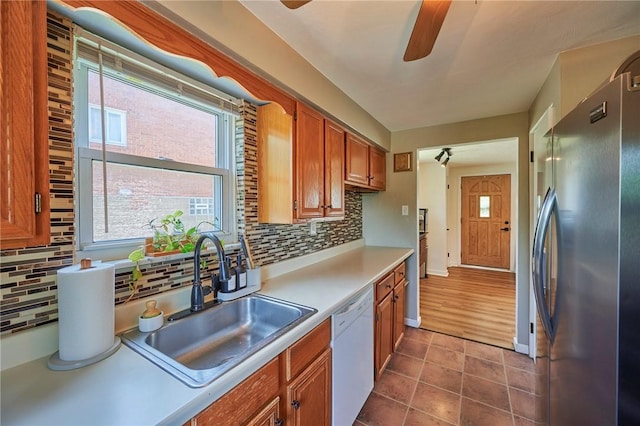 1023 Bellair Rd, Port Vue, PA 15133 - kitchen with freestanding refrigerator, white dishwasher, a ceiling fan, and decorative backsplash