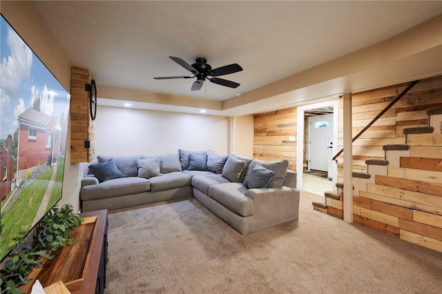 1023 Bellair Rd, Port Vue, PA 15133 - carpeted living room featuring wood walls, stairs, and a ceiling fan