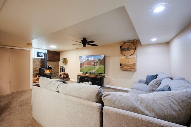 1023 Bellair Rd, Port Vue, PA 15133 - living room featuring carpet floors, a wood stove, recessed lighting, and a ceiling fan