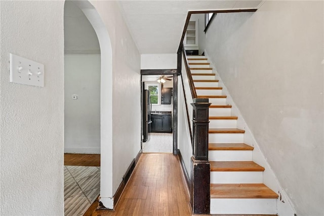 2600 Voelkel Ave, Beechview, PA 15216 - staircase featuring arched walkways, ceiling fan, and wood finished floors