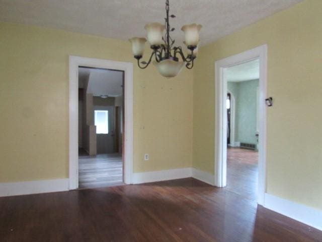 409 Keystone Dr, New Kensington, PA 15068 - spare room featuring a chandelier and dark wood-style floors