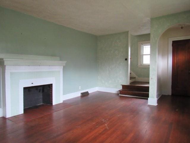409 Keystone Dr, New Kensington, PA 15068 - unfurnished living room featuring wood finished floors, a fireplace, and stairway