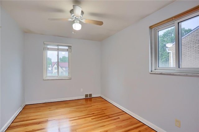 7034 Penn Ave, Point Breeze, PA 15208 - empty room with plenty of natural light, light wood-style flooring, and ceiling fan