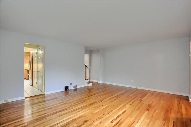 7034 Penn Ave, Point Breeze, PA 15208 - unfurnished room featuring light wood finished floors and stairway