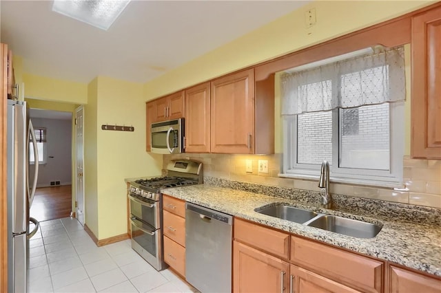 7034 Penn Ave, Point Breeze, PA 15208 - kitchen with stainless steel appliances, light tile patterned floors, decorative backsplash, and light stone countertops