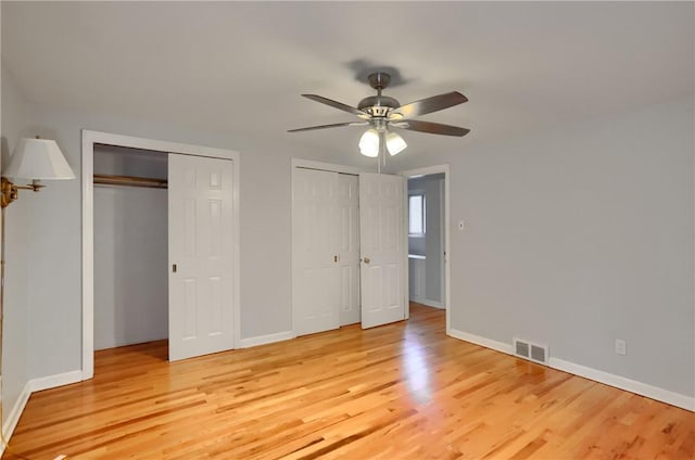 7034 Penn Ave, Point Breeze, PA 15208 - unfurnished bedroom featuring multiple closets, light wood-type flooring, and ceiling fan