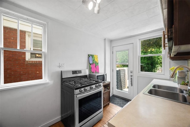 1229 Richmond St, Regent Square, PA 15218 - kitchen featuring appliances with stainless steel finishes, light wood-style flooring, light countertops, and a ceiling fan