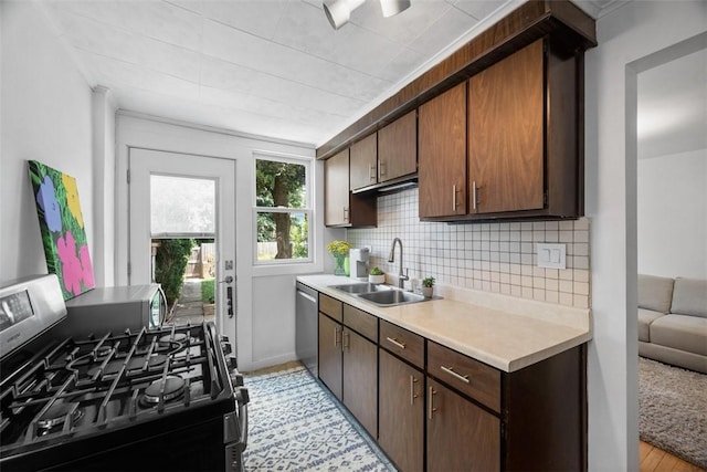 1229 Richmond St, Regent Square, PA 15218 - kitchen featuring stainless steel appliances, light countertops, decorative backsplash, and dark brown cabinetry