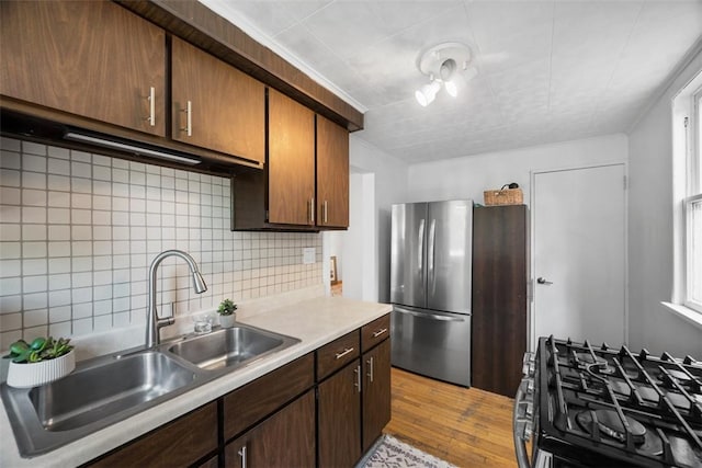 1229 Richmond St, Regent Square, PA 15218 - kitchen with gas range, light countertops, backsplash, light wood finished floors, and freestanding refrigerator