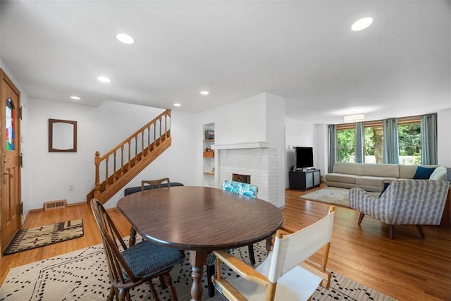 1229 Richmond St, Regent Square, PA 15218 - dining area featuring stairs, recessed lighting, light wood-style flooring, and a fireplace