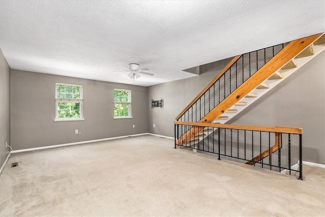 651 Newton Sq, Moon/Crescent Twp, PA 15108 - unfurnished living room with carpet flooring, ceiling fan, a textured ceiling, and stairway