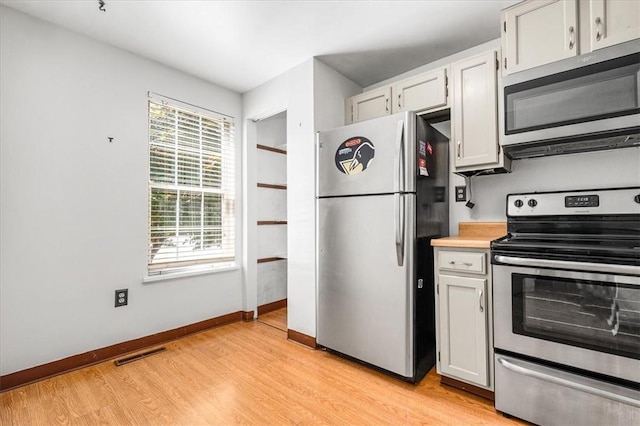651 Newton Sq, Moon/Crescent Twp, PA 15108 - kitchen with appliances with stainless steel finishes, light wood-type flooring, light countertops, and white cabinetry