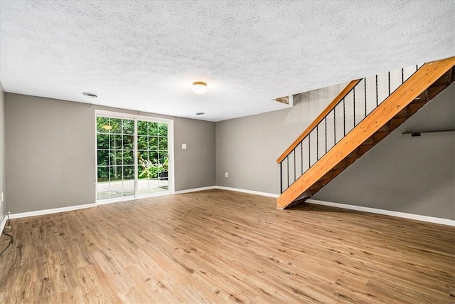 651 Newton Sq, Moon/Crescent Twp, PA 15108 - unfurnished living room with wood finished floors, stairway, and a textured ceiling