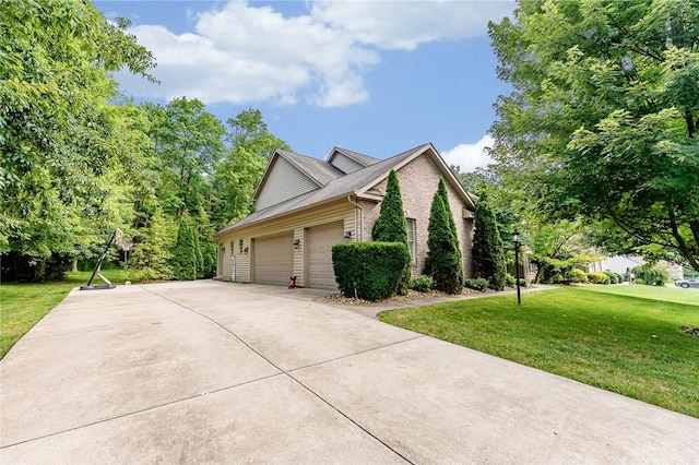 1044 Cross Creek Dr, South Union Twp, PA 15401 - view of side of property featuring brick siding, a lawn, an attached garage, and concrete driveway