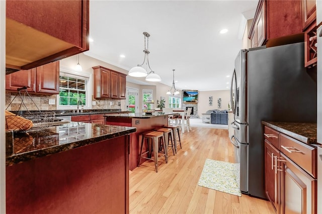 1044 Cross Creek Dr, South Union Twp, PA 15401 - kitchen with stainless steel refrigerator with ice dispenser, a kitchen island, open floor plan, decorative backsplash, and a breakfast bar