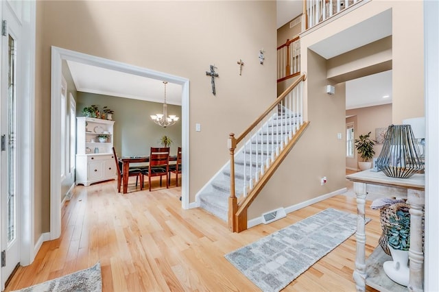 1044 Cross Creek Dr, South Union Twp, PA 15401 - entrance foyer featuring stairs, wood finished floors, crown molding, a chandelier, and a high ceiling