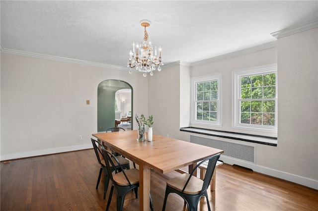 1302 Mount Royal Blvd, Shaler, PA 15223 - dining room with radiator, arched walkways, wood finished floors, a chandelier, and crown molding