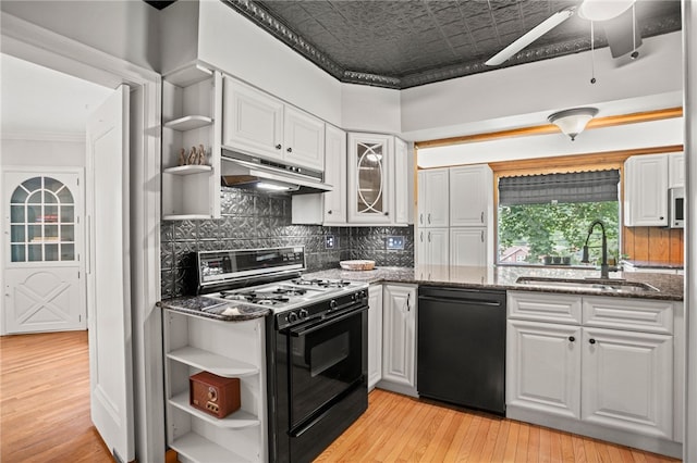 1302 Mount Royal Blvd, Shaler, PA 15223 - kitchen featuring gas stove, black dishwasher, open shelves, under cabinet range hood, and white cabinetry