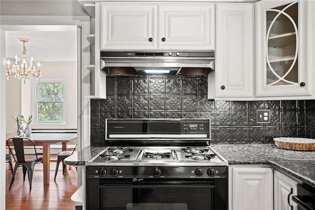 1302 Mount Royal Blvd, Shaler, PA 15223 - kitchen with black range with gas cooktop, under cabinet range hood, a chandelier, white cabinets, and backsplash