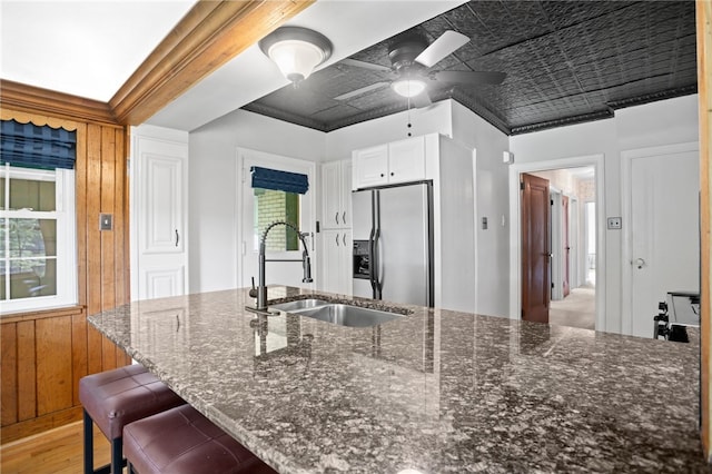 1302 Mount Royal Blvd, Shaler, PA 15223 - kitchen with stainless steel refrigerator with ice dispenser, light wood-style flooring, ceiling fan, dark stone countertops, and white cabinetry