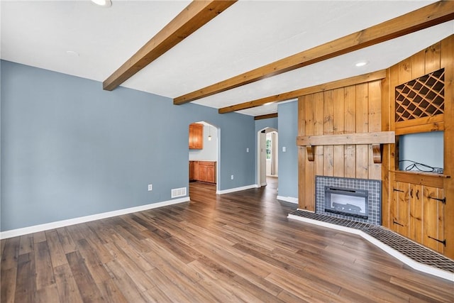 112 Oxford Pl, Saint Clair, PA 15241 - unfurnished living room featuring arched walkways, a fireplace, beamed ceiling, wood finished floors, and recessed lighting